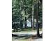 Home exterior surrounded by lush mature trees and wooded views at 5400 Kings Camp Rd, Acworth, GA 30102