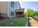 View of the backyard of the home featuring grass, patio, and second story deck at 5650 Upper Creek Ct, Suwanee, GA 30024