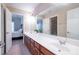 Bathroom featuring double sinks with granite countertops and a view into the adjoining bedroom at 5650 Upper Creek Ct, Suwanee, GA 30024