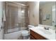 Well-lit bathroom with a shower-tub combo, toilet, and vanity with a sink at 5650 Upper Creek Ct, Suwanee, GA 30024