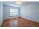 Bright bedroom with wood floors, a window letting in natural light, and neutral-colored walls at 5650 Upper Creek Ct, Suwanee, GA 30024