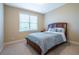 Cozy bedroom features neutral walls, a comfortable bed, and a window providing natural light at 5650 Upper Creek Ct, Suwanee, GA 30024