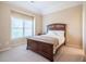 Inviting bedroom featuring a comfortable bed and a large window with pleasant natural lighting at 5650 Upper Creek Ct, Suwanee, GA 30024