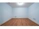 Bedroom featuring light blue walls and wood flooring, providing a calm living space at 5650 Upper Creek Ct, Suwanee, GA 30024