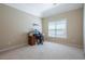Neutral bedroom with a desk near the window, providing ample natural light for a workspace at 5650 Upper Creek Ct, Suwanee, GA 30024