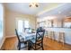 Sunny dining area features hardwood floors and counter with stools, perfect for casual meals at 5650 Upper Creek Ct, Suwanee, GA 30024