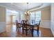 Spacious dining room featuring hardwood floors, crown molding, and a view into the foyer at 5650 Upper Creek Ct, Suwanee, GA 30024