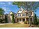 Charming brick home with mature trees, a two-car garage, and a welcoming front porch at 5650 Upper Creek Ct, Suwanee, GA 30024