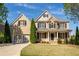 Inviting two-story brick home with a well-manicured lawn and a two-car garage at 5650 Upper Creek Ct, Suwanee, GA 30024