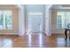 Bright foyer featuring hardwood floors, a white door with decorative glass, and large windows at 5650 Upper Creek Ct, Suwanee, GA 30024