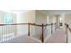 Upstairs hallway featuring views of other rooms and lots of natural light at 5650 Upper Creek Ct, Suwanee, GA 30024