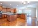 Well-lit eat-in kitchen with wooden cabinets, stainless steel appliances, granite countertops, and hardwood flooring at 5650 Upper Creek Ct, Suwanee, GA 30024
