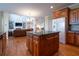 Traditional kitchen has wood cabinets, center island with granite countertops, and stainless steel appliances at 5650 Upper Creek Ct, Suwanee, GA 30024