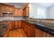Traditional kitchen features wooden cabinets, stainless steel appliances, and granite countertops at 5650 Upper Creek Ct, Suwanee, GA 30024