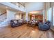 Bright and airy living room features hardwood floors, staircase, and opens to eat-in kitchen at 5650 Upper Creek Ct, Suwanee, GA 30024