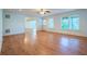 Spacious living room with hardwood floors, windows, and a ceiling fan at 5650 Upper Creek Ct, Suwanee, GA 30024