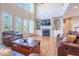 Bright living room features hardwood floors, built-in shelves, fireplace, and ample seating at 5650 Upper Creek Ct, Suwanee, GA 30024
