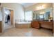Main bathroom features double vanities with tile floors and a garden tub at 5650 Upper Creek Ct, Suwanee, GA 30024
