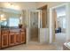 Main bathroom featuring double vanities and a tiled shower with glass doors at 5650 Upper Creek Ct, Suwanee, GA 30024