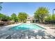 View of the community pool, showcasing sparkling water, lounge chairs and lush trees surrounding the area at 5650 Upper Creek Ct, Suwanee, GA 30024