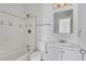 Bright bathroom with a shower-tub combo, white tile, and a vanity with sink at 934 Joseph E Boone Nw Blvd, Atlanta, GA 30314