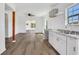 Bright kitchen featuring white cabinets, granite countertops, stainless steel sink, and tiled backsplash at 934 Joseph E Boone Nw Blvd, Atlanta, GA 30314