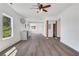 Bright, open-concept living room with grey-toned flooring and modern ceiling fan fixture at 934 Joseph E Boone Nw Blvd, Atlanta, GA 30314
