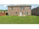 Home backyard with a lush green lawn, a cozy patio, and a well-maintained brick exterior at 368 Sawyer Meadow Way, Grayson, GA 30017