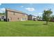 Expansive backyard with lush green lawn, mature trees, and view of the home's exterior at 368 Sawyer Meadow Way, Grayson, GA 30017