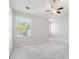 Bright bedroom features neutral walls, plush carpet, ceiling fan, and natural light from a large window at 368 Sawyer Meadow Way, Grayson, GA 30017