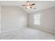 Bright bedroom features neutral walls, plush carpet, ceiling fan, and natural light from a large window at 368 Sawyer Meadow Way, Grayson, GA 30017