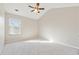 Bright bedroom features neutral walls, plush carpet, ceiling fan, and natural light from a large window at 368 Sawyer Meadow Way, Grayson, GA 30017