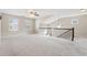 A large, carpeted bonus room features a vaulted ceiling and a wrought iron railing at 368 Sawyer Meadow Way, Grayson, GA 30017