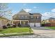 Charming two-story brick home with a well-manicured lawn and a two-car garage at 368 Sawyer Meadow Way, Grayson, GA 30017