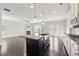 Open kitchen features an island, stainless appliances, and a view of the living area at 368 Sawyer Meadow Way, Grayson, GA 30017
