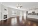 Open living room with fireplace, hardwood floors, and access to the kitchen at 368 Sawyer Meadow Way, Grayson, GA 30017