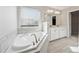 Beautiful bathroom featuring a large soaking tub, tiled floors, and a double vanity at 368 Sawyer Meadow Way, Grayson, GA 30017