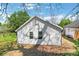 Exterior showcasing the backyard of a light-colored home featuring tidy lawn and new siding at 944 Joseph E Boone Nw Blvd, Atlanta, GA 30314