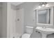 A full bathroom features a shower, toilet, and pedestal sink with modern fixtures at 944 Joseph E Boone Nw Blvd, Atlanta, GA 30314