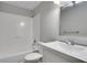 Clean, well-lit bathroom with a white vanity, tub, and tiled shower at 944 Joseph E Boone Nw Blvd, Atlanta, GA 30314