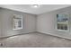 A bedroom featuring neutral paint, plush carpeting, and large windows offering natural light at 944 Joseph E Boone Nw Blvd, Atlanta, GA 30314