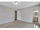 A view of a carpeted bedroom leads to an ensuite bathroom with sleek fixtures at 944 Joseph E Boone Nw Blvd, Atlanta, GA 30314