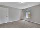 This is a bedroom featuring neutral walls, plush carpet and a window with natural light at 944 Joseph E Boone Nw Blvd, Atlanta, GA 30314