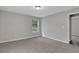 A bright bedroom with soft carpet, a large window, and serene, gray-painted walls at 944 Joseph E Boone Nw Blvd, Atlanta, GA 30314