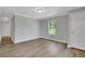 A sunny bedroom has wood floors, light gray walls, and white trim at 944 Joseph E Boone Nw Blvd, Atlanta, GA 30314