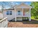Charming cottage-style home with a red front door and elevated porch, perfect for enjoying the outdoors at 944 Joseph E Boone Nw Blvd, Atlanta, GA 30314