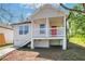 Charming cottage-style home with a red front door and elevated porch, perfect for enjoying the outdoors at 944 Joseph E Boone Nw Blvd, Atlanta, GA 30314