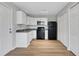 An efficient kitchen boasts white cabinets, granite countertops and black appliances at 944 Joseph E Boone Nw Blvd, Atlanta, GA 30314