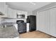 Well-lit kitchen with white cabinets, black appliances, and modern finishes at 944 Joseph E Boone Nw Blvd, Atlanta, GA 30314