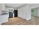 This kitchen features white cabinets, modern appliances, and durable laminate wood flooring at 944 Joseph E Boone Nw Blvd, Atlanta, GA 30314